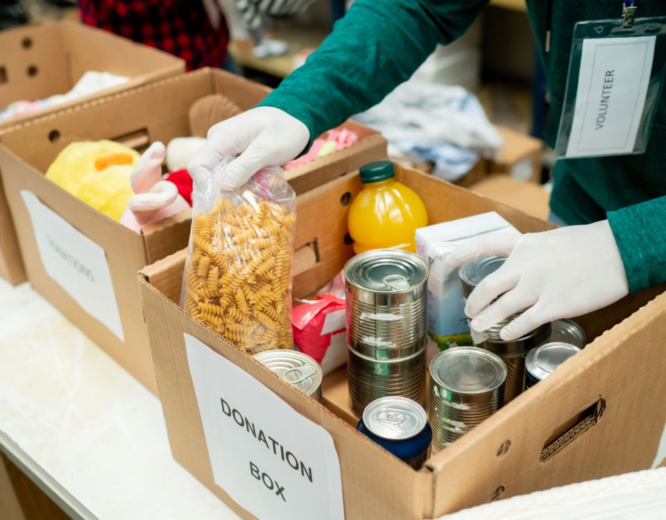 Volunteers load food donations into a box